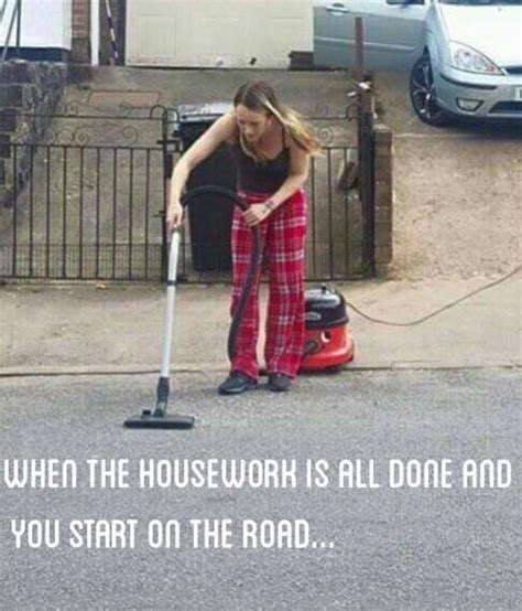 A Woman Is Cleaning The Street With A Vacuum