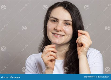 A Brunette Woman Brushes Her Teeth With Flossing Oral Hygiene Plaque