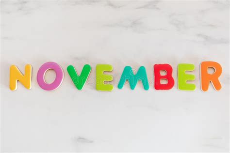 November Word Written With Colorful Letters On Wooden Background Stock