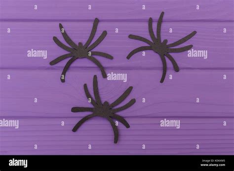 The Spiders Halloween Silhouettes Cut Out Of Paper On Purple Wooden