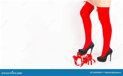 santa woman legs in shoes with heels with christmas t on white background christmas shopping