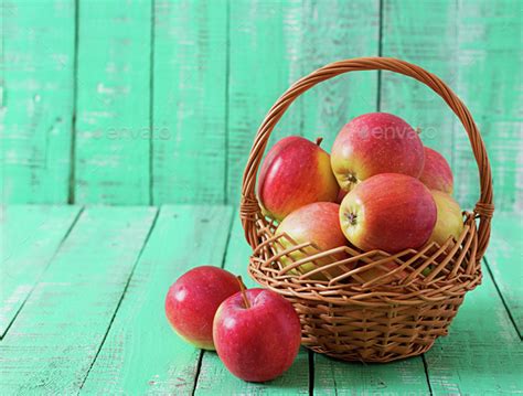 Ripe Red Apples In A Basket On A Bright Wooden Background Stock Photo