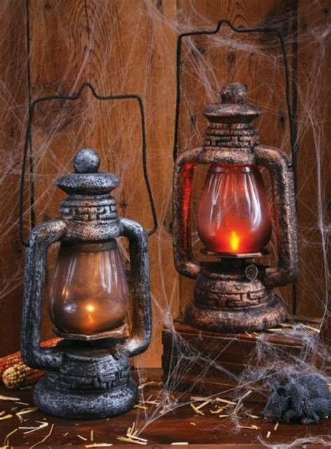 Two Old Fashioned Lanterns Sitting Next To Each Other On Top Of A