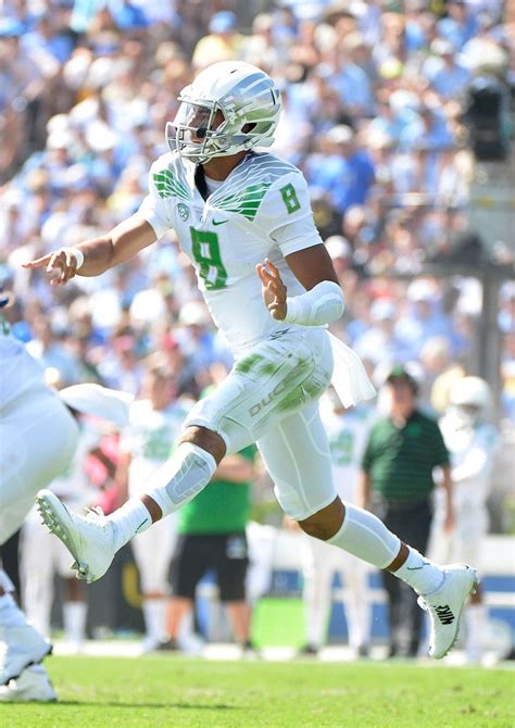 Marcus Mariota 8 Of The Oregon Ducks Throws On The Run During The