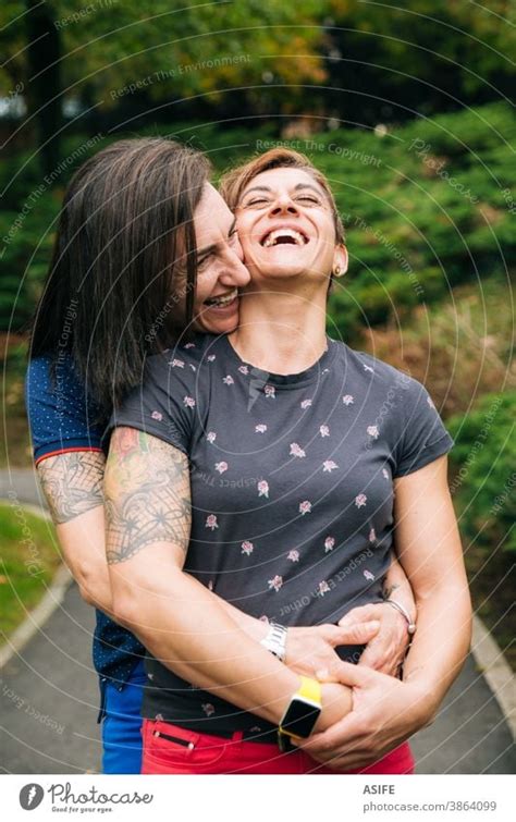 Laughing Middle Aged Lesbian Couple Hugging Outdoor A Royalty Free