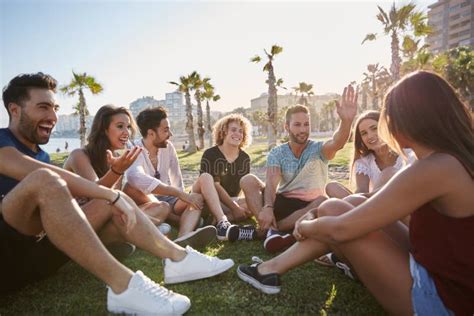 Group Of Friends Sitting In Circle Talking Outside Stock Photo Image