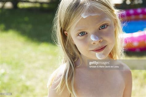 Girl With Sunscreen Cream On Her Face Photo Getty Images