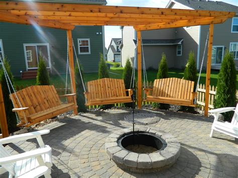 Swings around a fire pit. Stone fire pit ideas Rosemount, MN | Devine Design Hardscapes