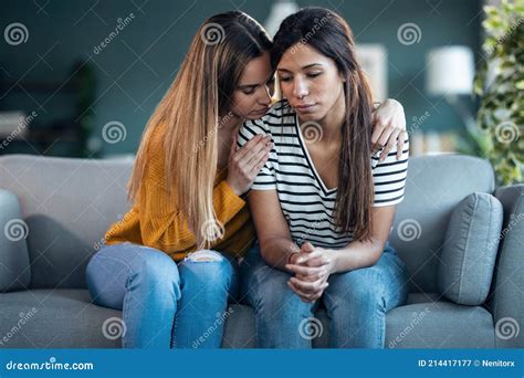 Pretty Young Woman Supporting And Comforting Her Sad Friend While