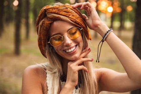 Photo Of Joyful Hippie Woman Wearing Stylish Accessories Smiling While Walking In Forest Stock