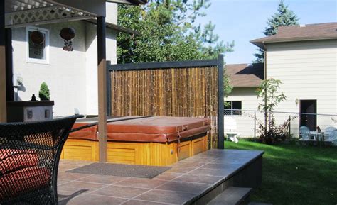 In this case the owners of the hot tub went as natural as their surroundings with a simple diy wood frame made of loose tree limbs that matched their spa case. Bamboo Innovations | Our Privacy Screens Portfolio | Patio ...