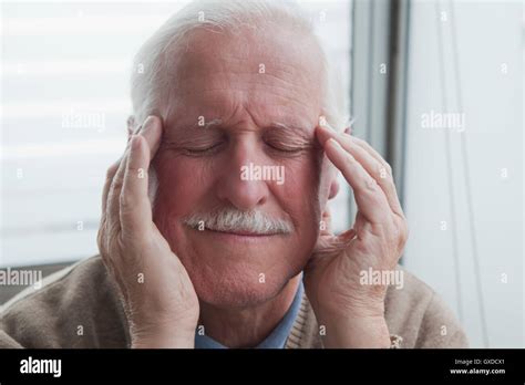 Senior Man Suffering From Headache Stock Photo Alamy