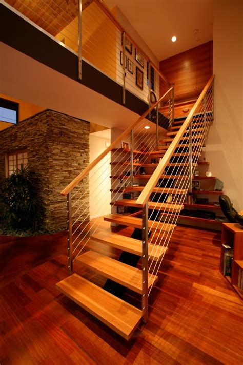 Matching the wood of the handrail to the wood of the stairs. Floating Modern Staircase With Cable Railing | HGTV