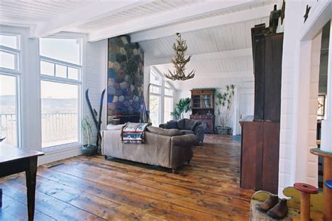 This rustic living room contains a comfortable vintage style lounge chair along with two types of sofas in shades of brown and beige. Antique Wood Flooring - Rustic - Living Room - calgary - by Uniquities Architectural Antiques ...