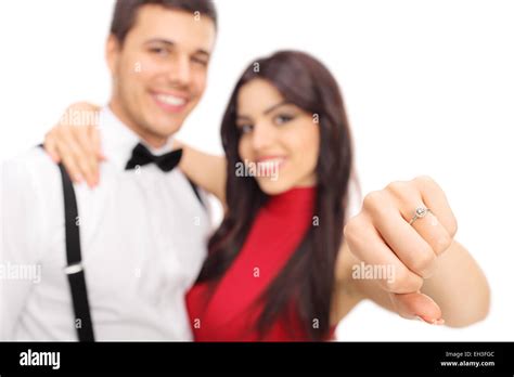 Woman Posing With Her Fiancée And Showing Her Engagement Ring With The Focus On The Ring
