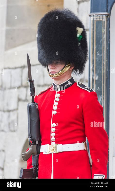 Soldier In Queens Guard At Windsor Castle England With Red Uniform