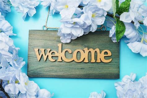 Welcome Sign And Flower Blooming Decoration On Blue Background Stock