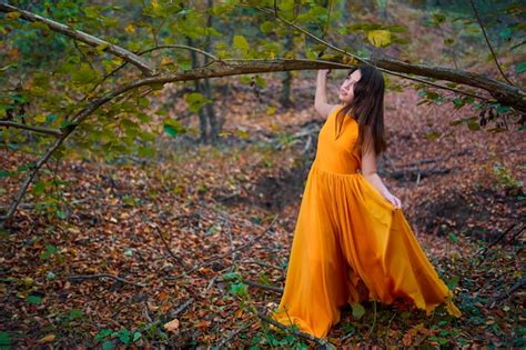 Premium Photo Teenage Girl In Yellow Dress In The Forest