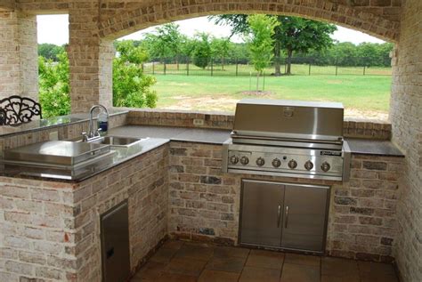 L Shaped White Exposed Brick Outdoor Island With Stainless Steel