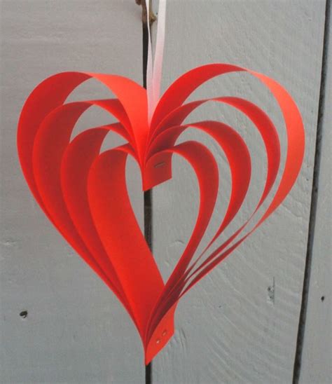 A Red Paper Heart Hanging From A Hook