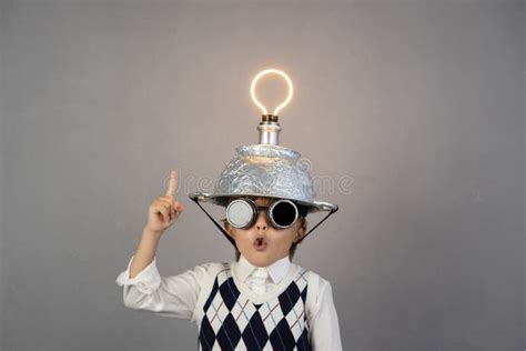 Smart Child Wearing Funny Helmet With Illuminated Lightbulb Stock Image