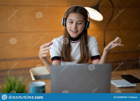 Smiling Young Asian Woman In Headset Wave Greet Talking On Webcam