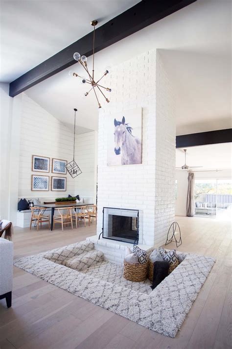 Cozy Carpeted Fireplace Lounge Space Under White Brick Chimney And