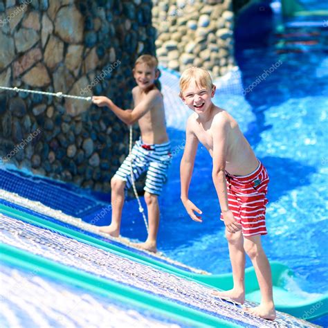 Two Boys Having Fun In Water Park Stock Photo By ©cromary 68115307