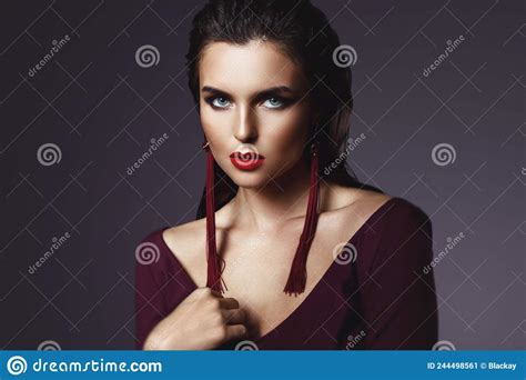 stunning woman with a beautiful makeup wearing long red earrings stock image image of