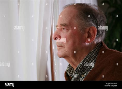Elderly Man Looking Out Window Stock Photo Alamy