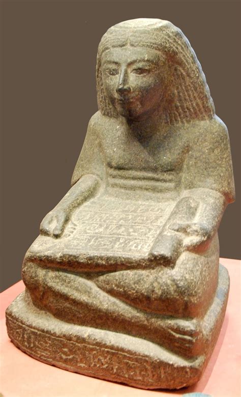 Ancient Egyptian Statue Carved From Diorite Of A Seated Scribe Holding A Papyrus Scrol