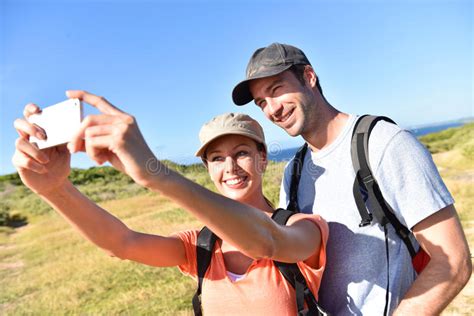 Couple Of Hikers Taking Selfie Souvenir From Tropical Islands Stock