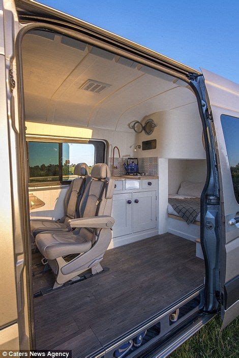The Interior Of A Camper Van With Its Door Open And Chairs In The Back