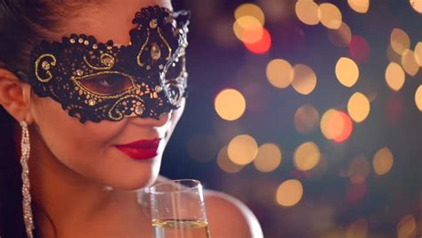 Sexy Woman Wearing Venetian Masquerade Carnival Mask At Party Over Holiday Glowing Background