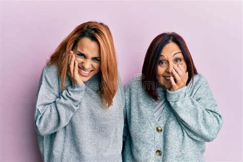 Latin Mother And Daughter Wearing Casual Clothes Laughing And Embarrassed Giggle Covering Mouth