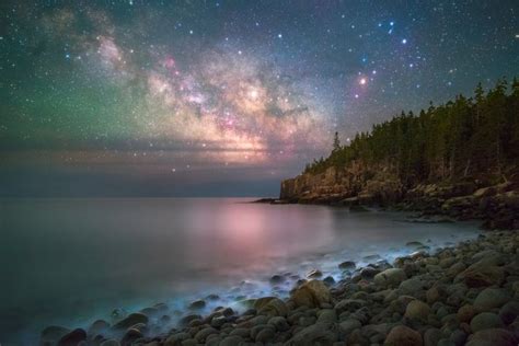 A Brilliant Starry Night Shines Above The Rocky Coast Of Maines Acadia