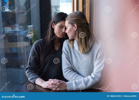 Lesbian Couple Of Women On A Date In A Cafe Two Gay Girlfriends Hold