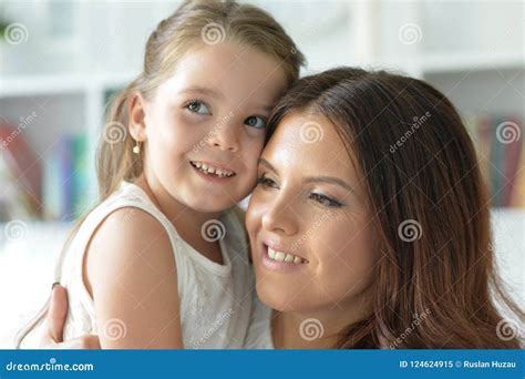 Close Up Portrait Of A Charming Little Girl Hugging With Mom Stock