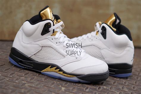 The white upper gets the olympic theme by utilizing the black and gold accents placed throughout the shoe. Air Jordan 5 Olympic White Black Gold Release Date - Sneaker Bar Detroit