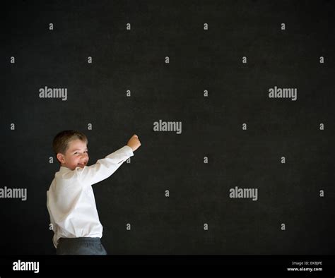 Boy Dressed Up As Businessman Writing On Blackboard Stock Photo Alamy