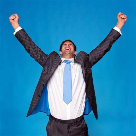 Businessman Celebrating With Arms Raised In The Air Stock Photo Image