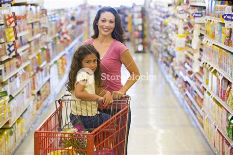 Mother And Daughter Grocery Shopping In Supermarket Royalty Free Stock