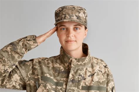 Premium Photo Young Adult Woman Soldier Saluting With Hand Near Head