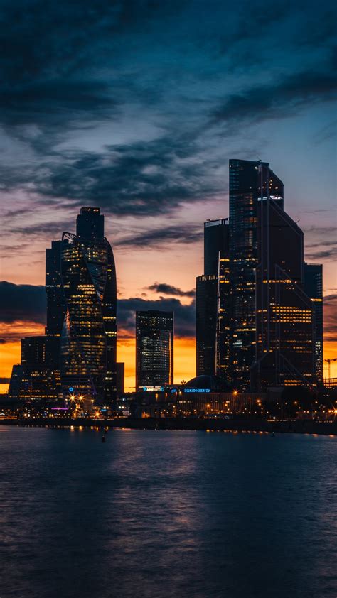 Download Wallpaper 1350x2400 Skyscrapers Night City Sunset Buildings