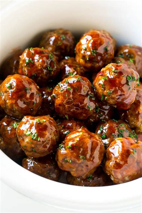 Sweet And Sour Meatballs Garnished With Parsley In A Slow Cooker