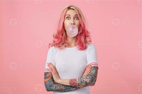 Young Surprised Beautiful Pink Haired Woman With Tattooed Hands Wears