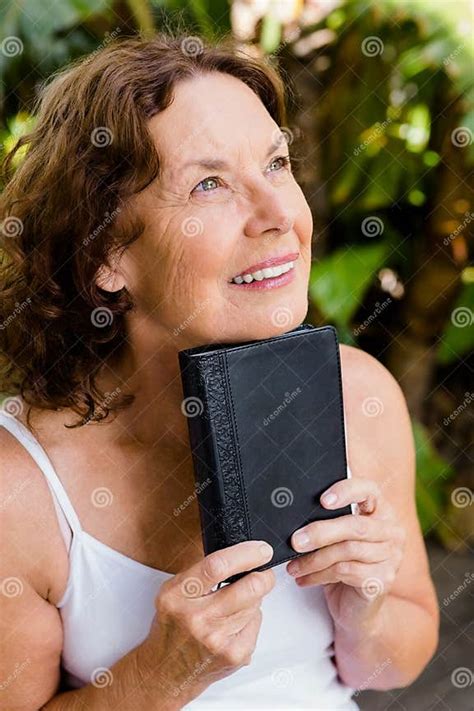 Smiling Mature Woman Holding Bible Stock Image Image Of Outdoors