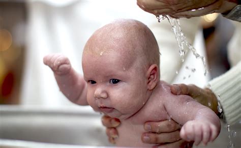 Orthodox baptism of a child.Baby in the baptismal font in the church