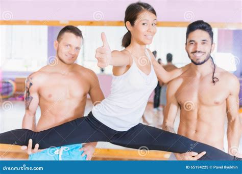 Young Beautiful Asian Woman Doing Split Between Two Guys Stock Image