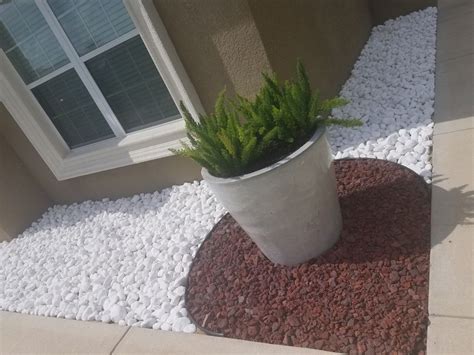 Spray the rocks with water from your garden hose to wash away dirt and dust. Snow white rocks and lava rocks | Landscaping with rocks ...